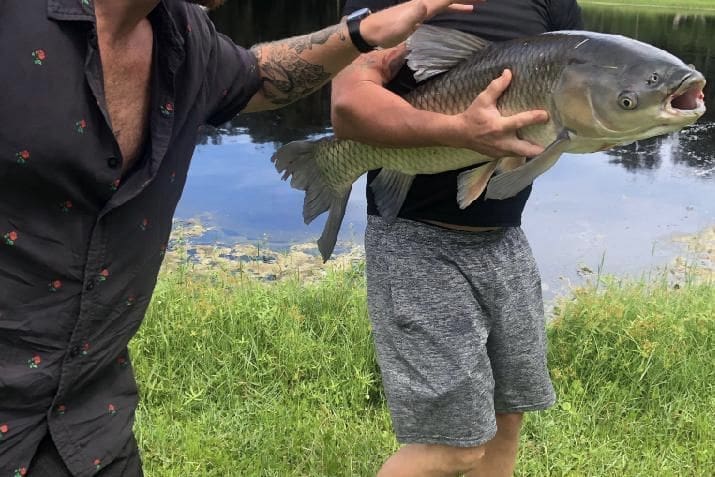 Residential treatment patient holding a large fish he caught